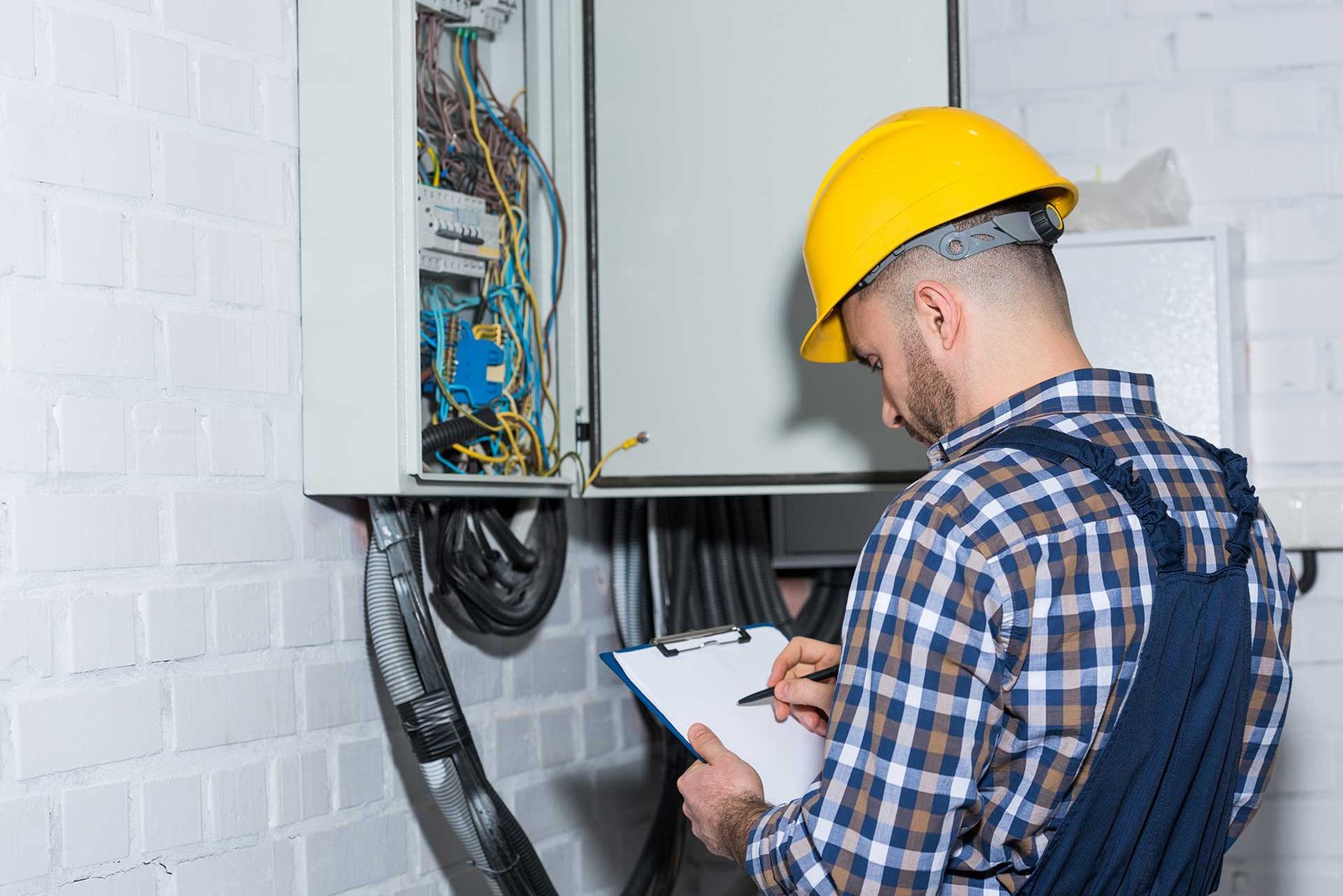 professional-electrician-inspecting-wires-in-elect-YEB3RXQb.jpg